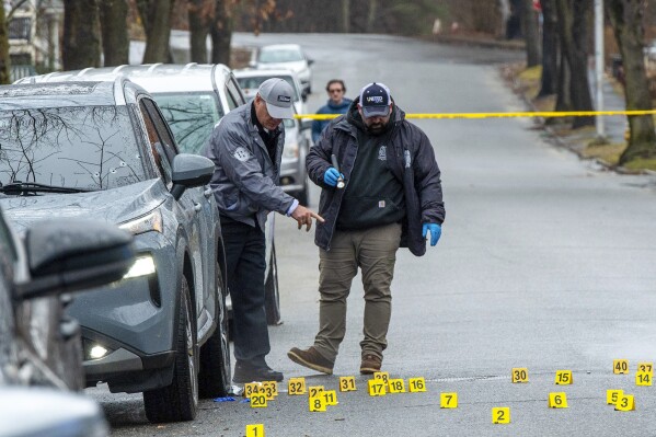 Worcester Police investigate a shooting on Tuesday, March 5, 2024 in Worcester, Mass. A mother and her 11-year-old daughter were fatally shot while sitting in a parked SUV in a Massachusetts neighborhood. Police arrested one man and were searching for another.(Rick Cinclair/Worcester Telegram & Gazette via AP)