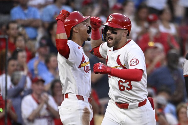 St. Louis Cardinals' Michael Siani (63), right, celebrates with teammate Masyn Winn, left, after hitting a three-run home run in the fourth inning of a baseball game against the Baltimore Orioles, Monday, May 20, 2024, in St. Louis. (AP Photo/Joe Puetz)
