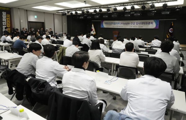Trainee doctors attend a meeting at the Korea Medical Association building in Seoul, South Korea, Tuesday, Feb. 20, 2024. South Korean trainee doctors collectively walked off their jobs Tuesday to escalate their protest of a government medical policy, triggering cancellations of surgeries and other medical treatments at hospitals. (AP Photo/Ahn Young-joon)