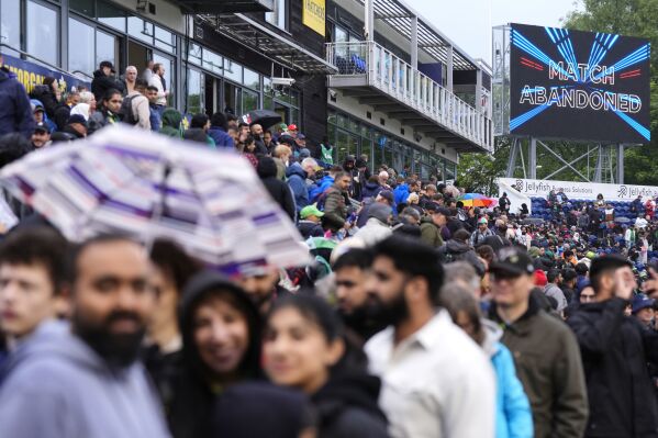 Fans leave the ground as the big screen announces the match has been abandoned at the third IT20 match at Sophia Gardens, Cardiff, Tuesday May 28, 2024. Bad weather forced the abandonment of the T20 match between England and Pakistan in Cardiff. (Nick Potts/PA via AP)