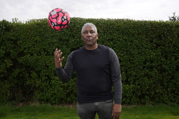 Former England international soccer player Ricky Hill poses for a photograph in Luton, England, Wednesday, March 20, 2024. Racism has long permeated the world’s most popular sport, with soccer players subjected to racist chants and taunts online. While governing bodies like FIFA and UEFA have taken steps to combat the abuse of players, the lack of diversity in the upper ranks at major clubs remains an unsolved problem. Hill has just left the U.K. to take a management position with a suburban Chicago soccer club. (AP Photo/Kin Cheung)