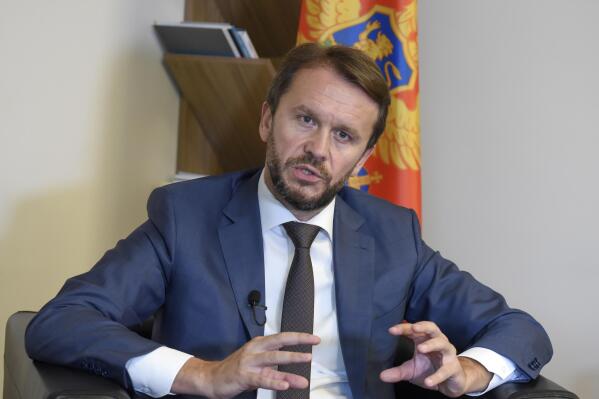 Montenegro's Defense Minister Rasko Konjevic speaks during an interview with The Associated Press in Podgorica, Montenegro, Wednesday, Sept. 7, 2022. At the government headquarters in NATO- member Montenegro, computers are unplugged, internet is offline and the main state websites are down. The blackout comes amid a massive cyberattack against the small Balkan state which officials say bears the hallmarks of Russian hackers and its security services. (AP Photo/Risto Bozovic)