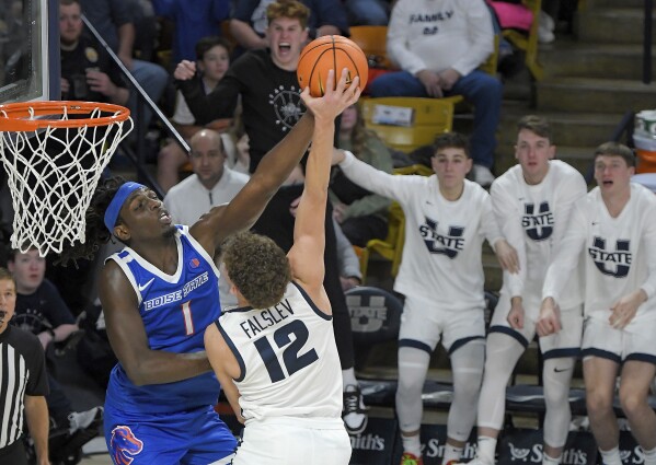 El delantero de Boise State, O'Mar Stanley (1), hace falta al guardia del estado de Utah, Mason Falslev (12), durante la segunda mitad de un partido de baloncesto universitario de la NCAA el sábado 10 de febrero de 2024 en Logan, Utah.  (Eli Lucero/The Herald Journal vía AP)