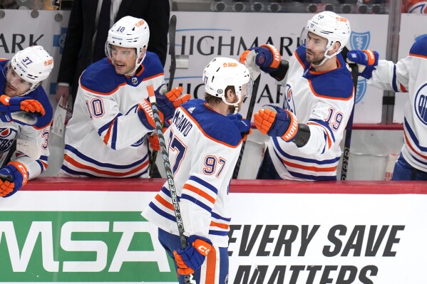 Edmonton Oilers' Connor McDavid (97) returns to his bench after scoring during the first period of an NHL hockey game against the Pittsburgh Penguins in Pittsburgh, Sunday, March 10, 2024. (AP Photo/Gene J. Puskar)