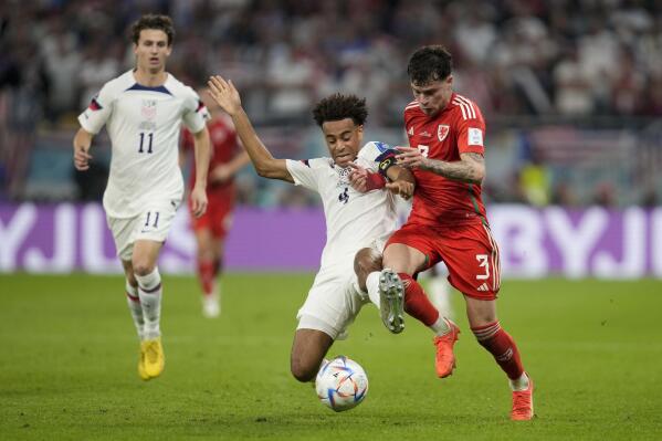 FILE - Tyler Adams of the United States (4), and Wales' Ben Davies vie for the ball during the World Cup, group B soccer match between the United States and Wales, at the Ahmad Bin Ali Stadium in in Doha, Qatar, Monday, Nov. 21, 2022. Tyler Adams was voted the U.S. Soccer Federation’s Male Player of the Year for the first time on Friday, Jan. 13, 2023, after becoming the youngest captain at last year’s World Cup.(AP Photo/Darko Vojinovic, File)