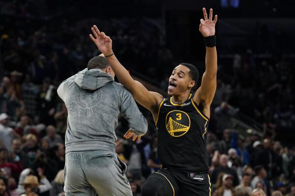 Golden State Warriors guard Stephen Curry, left, celebrates a score with teammate guard Jordan Poole (3) during the second half of an NBA basketball game against the San Antonio Spurs, Tuesday, Feb. 1, 2022, in San Antonio. (AP Photo/Eric Gay)