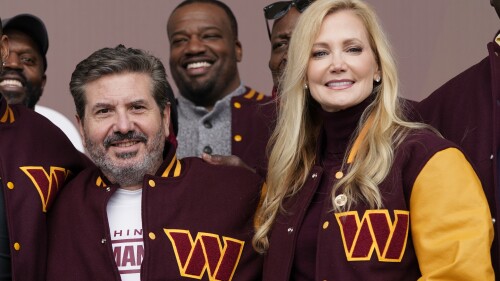 FILE - Dan and Tanya Snyder, co-owner and co-CEOs of the Washington Commanders, pose for photos after unveiling their NFL football team's new identity, Wednesday, Feb. 2, 2022, in Landover, Md. NFL owners unanimously approved the sale of the Washington Commanders on Thursday, July 2023, from Dan Snyder to a group led by Josh Harris and including Magic Johnson for a record $6.05 billion. (AP Photo/Patrick Semansky, File)