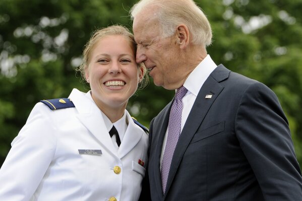 
              FILE - In this May 22, 2013 file photo, Newly commissioned officer Erin Talbot, left, poses for a photograph with Vice President Joe Biden during commencement for the United States Coast Guard Academy in New London, Conn. As former Vice President Biden's camp scrambles to contain any political damage over his past behavior with women, House Speaker Nancy Pelosi has some words of advice: Keep your distance.  (AP Photo/Jessica Hill)
            