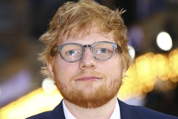 FILE - In this June 18, 2019 file photo, singer Ed Sheeran poses for photographers upon arrival at the premiere of the film 'Yesterday' in London. Sheeran’s Divide Tour is one for the record books. Pollstar confirms the 28-year-old British singer’s tour will set the all-time highest-grossing tour record with Friday, Aug. 2,  show in Hannover, Germany. Pollstar forecasts the total gross to this point of $736.7 million will top the previous record of $735.4 million set by U2 in 2011.(Photo by Joel C Ryan/Invision/AP, File)