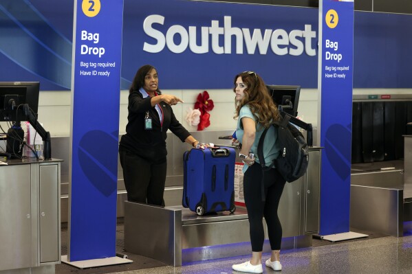 A passenger checks in for her Southwest Airlines flight at Midway International Airport in Chicago, Thursday, July 25, 2024. Southwest Airlines plans to drop the open-boarding system it has used for more than 50 years and will start assigning passengers to seats, just like all the other big airlines. (ĢӰԺ Photo/Teresa Crawford)
