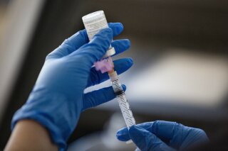 RN Connie Garcia extracts a dose of the Moderna Covid-19 vaccine which will be administered to a Texas Tech University Health Science Center student at Texas Tech University Health Science Center's Academic Building Monday, Jan. 4, 2021, in Odessa, Texas. (Jacob Ford/Odessa American via AP)