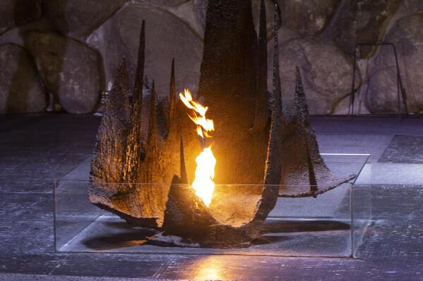FILE - The Eternal Flame glows in the Hall of Remembrance at the Yad Vashem Holocaust Museum in Jerusalem, Wednesday, June 16, 2020. Israeli researchers say the coronavirus pandemic and the Israel-Gaza war fueled a spike in antisemitism around the world in 2021. (Heidi Levine/Pool via AP, File)