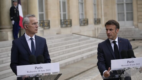 French President Emmanuel Macron, right, and NATO Secretary General Jens Stoltenberg speak to reporters before their talks Wednesday, June 28, 2023 at the Elysee Palace in Paris. NATO Secretary-General Jens Stoltenberg said earlier that he has called a meeting of senior officials from Turkey, Sweden and Finland on July 6 to try to overcome Turkish objections to Sweden joining the military organization. (AP Photo/Christophe Ena)