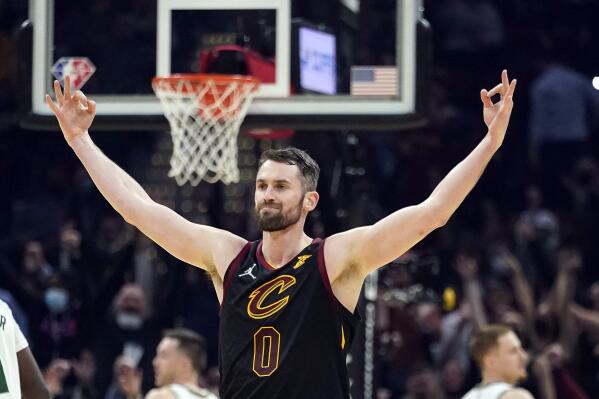 Cleveland Cavaliers' Kevin Love (0) reacts after hitting a 3-point shot in the first half of an NBA basketball game against the Milwaukee Bucks, Wednesday, Jan. 26, 2022, in Cleveland. (AP Photo/Tony Dejak)
