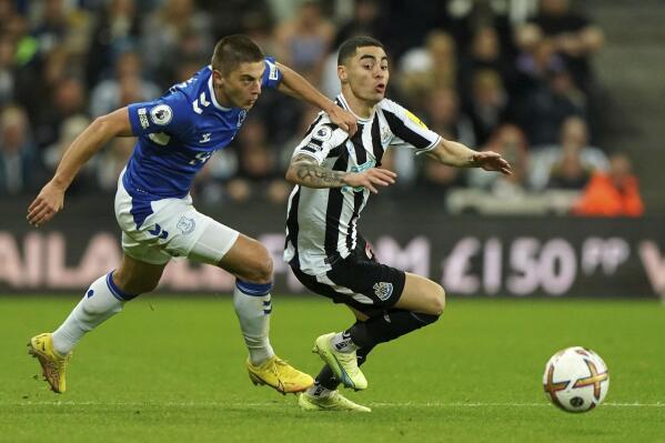 Everton's Vitaliy Mykolenko, left, and Newcastle United's Miguel Almiron battle for the ball during the English Premier League soccer match at St. James' Park, Newcastle upon Tyne, England, Wednesday Oct. 19, 2022. (Owen Humphreys/PA via AP)
