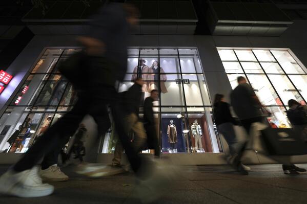 FILE - People walk past a store at the famous shopping road Kurfuerstendamm, better known as 'Kudamm', in Berlin, Germany, on Oct. 11, 2022. Data released Thursday May 25, 2023 by the Federal Statistical Office shows the German economy shrank unexpectedly in the first three months of this year, marking the second quarter of contraction that is one definition of recession. (AP Photo/Michael Sohn, File)