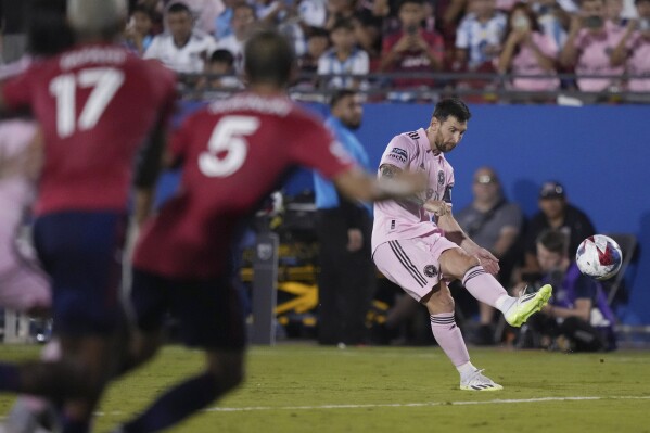 Inter Miami forward Lionel Messi, right, takes a free kick as FC Dallas midfielder Facundo Quignon (5) and defender Nkosi Tafari (17) watch during the second half of a Leagues Cup soccer match Sunday, Aug. 6, 2023, in Frisco, Texas. (AP Photo/LM Otero)