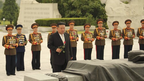 In this photo provided by the North Korean government, North Korean leader Kim Jong Un, foreground, prepares to offer a flower at a liberation war martyrs cemetery in Pyongyang, North Korea Tuesday, July 25, 2023, on the occasion of the 70th anniversary of the armistice that halted fighting in the 1950-53 Korean War. Independent journalists were not given access to cover the event depicted in this image distributed by the North Korean government. The content of this image is as provided and cannot be independently verified. Korean language watermark on image as provided by source reads: 