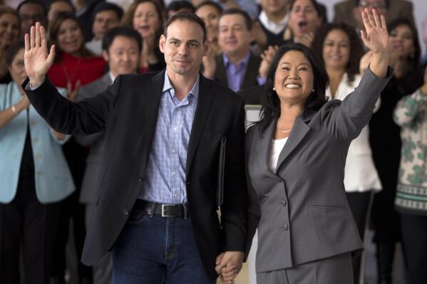 FILE - Keiko Fujimori waves to the press after conceding defeat in the presidential election accompanied by her husband Mark Villanella, in Lima, Peru, June 10, 2016. The former Peruvian presidential candidate and daughter of imprisoned ex-President Alberto Fujimori, posted on her twitter account, Tuesday, June 21, 2022, that she is ending her marriage. (AP Photo/Martin Mejia, File)