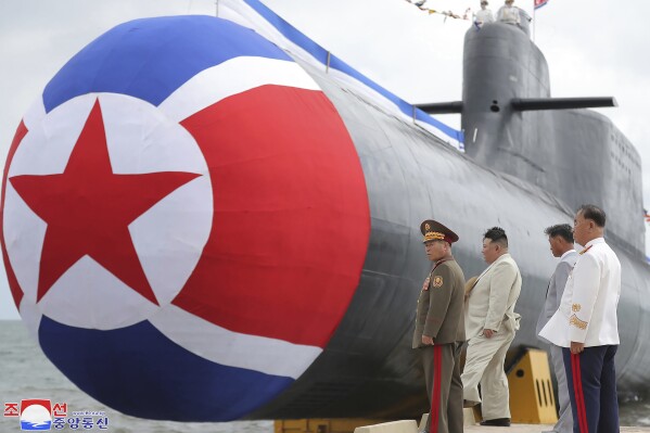 In this photo provided by the North Korean government, North Korea leader Kim Jong Un, second left, looks at what is says a new nuclear attack submarine "Hero Kim Kun Ok" at an unspecified place in North Korea Wednesday, Sept. 6, 2023. Independent journalists were not given access to cover the event depicted in this image distributed by the North Korean government. The content of this image is as provided and cannot be independently verified. Korean language watermark on image as provided by source reads: "KCNA" which is the abbreviation for Korean Central News Agency. (Korean Central News Agency/Korea News Service via AP)