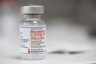 FILE - A vial of the Moderna COVID-19 vaccine is displayed on a counter at a pharmacy in Portland, Ore. on Dec. 27, 2021. A government advisory panel met Tuesday, June 14, 2022,  to decide whether to recommend a second brand of COVID-19 vaccine for school-age children and teens. The Food and Drug Administration's outside experts will vote on whether Moderna's vaccine is safe and effective enough to give kids ages 6 to 17.  If the panel endorses the shot and the FDA agrees, it would become the second option for those children, joining Pfizer's vaccine.(AP Photo/Jenny Kane, File)