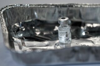 A vial of the Pfizer-BioNTech COVID-19 vaccine, as the mass public vaccination program gets underway, at the NHS Louisa Jordan Hospital in Glasgow, Scotland, Tuesday Dec. 8, 2020. The United Kingdom is beginning its vaccination campaign with vulnerable, the elderly and key workers among the first people to be inoculated against the COVID-19 virus. (Jeff J Mitchell/Pool via AP)