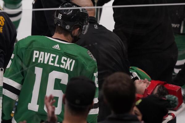 Dallas Stars center Tanner Kero, right, is taken off the ice as teammate Joe Pavelski (16) looks on after a hit by Chicago Blackhawks right wing Brett Connolly during the first period of an NHL hockey game in Dallas, Saturday, Dec. 18, 2021. (AP Photo/LM Otero)