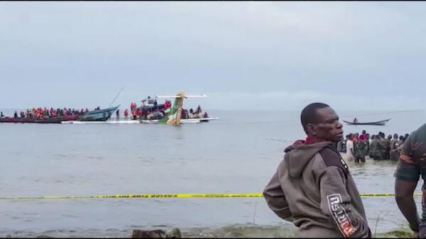 Rescuers in boats are seen around the tail fin of a crashed Precision Air passenger aircraft on the shores of Lake Victoria in Bukoba, in western Tanzania Sunday, Nov. 6, 2022. The small passenger plane crashed Sunday morning into Lake Victoria near Bukoba airport and the company Precision Air said the flight was coming from the coastal city of Dar es Salaam, though it was not immediately clear how many people were on board. (AYO TV via AP)