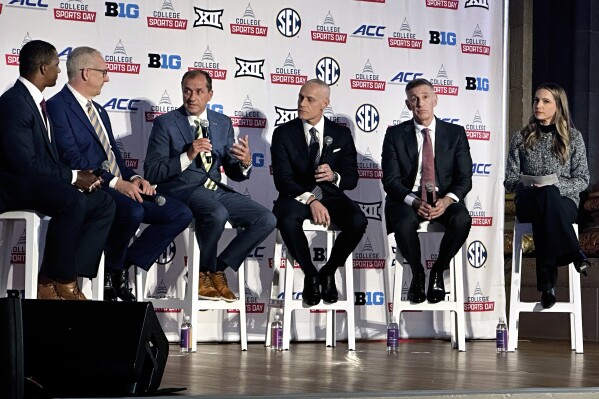 The Commissioners of the NCAA's power four conferences, SEC's Greg Sankey, ACC's Jim Phillips, Big 12's Brett Yormark and Big Ten's Tony Petitti speak with ESPN's Roddy Jones, left, and Dana Boyle, right, at the College Sports Day on Capitol Hill reception in Washington, D.C., on Wednesday, April 9, 2025, after they lobbied lawmakers earlier in the day for legislation to standardize name, image and likeness and other rules. (AP Photo/Stephen Whyno )