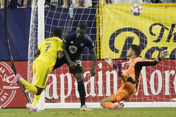 Nashville SC forward Abu Danladi (7) scores a goal against CF Montreal goalkeeper James Pantemis, right, during the second half of an MLS soccer match Saturday, June 26, 2021, in Nashville, Tenn. (AP Photo/Mark Humphrey)