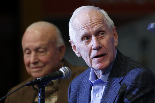 FILE - With former Illinois and New Mexico coach Lou Henson, left, by his side, retired Dayton coach Don Donoher talks about his career, during a news conference prior to a National Collegiate Basketball Hall of Fame induction event, Nov. 20, 2015, in Kansas City, Mo. Donoher, the winningest basketball coach at Dayton and a member of the National Collegiate Basketball Hall of Fame, has died. He was 92. The university announced Donoher's death on Friday night, April 12, 2024. No cause of death was given. (AP Photo/Colin E. Braley, File)