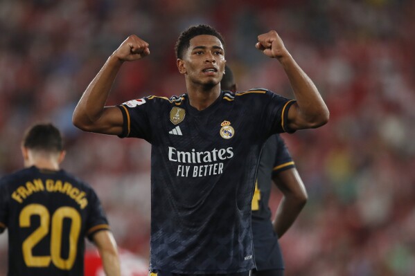 FILE - Real Madrid's Jude Bellingham celebrates after scoring his side's second goal during a Spanish La Liga soccer match against Almeria at the Power Horse Stadium in Almeria, Spain, Saturday, Aug. 19, 2023. Real Madrid was confident it had locked up the heir to Luka Modric when it signed Jude Bellingham in the offseason. The 14-time European champions hadn’t counted on also getting a streak scorer. The 20-year-old England midfielder leads the Spanish league with four goals in three games (AP Photo/Fermin Rodriguez, file)