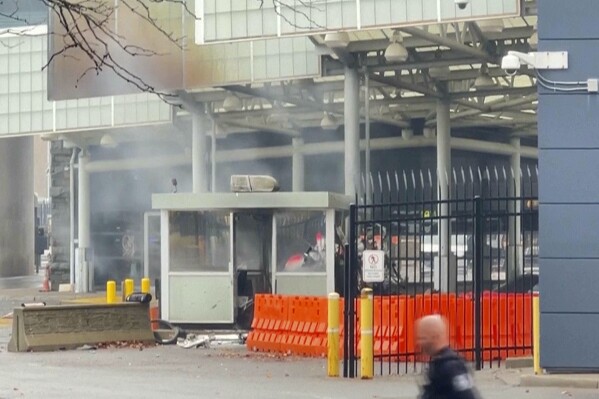 In this photo taken from video provided by WKBW-TV, smoke billows from a checkpoint at the Rainbow Bridge, Wednesday, Nov. 22, 2023, in Niagara Falls, N.Y. A vehicle exploded at a checkpoint on the American side of a U.S.-Canada bridge in Niagara Falls Wednesday, leaving two people dead and prompting the closing of four border crossings in the area, authorities said. (WKBW-TV via AP)