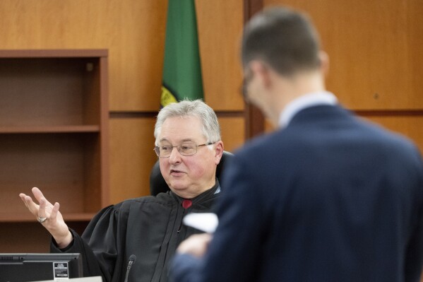 Judge Bryan Chushcoff rules on what will be allowed in the state's closing arguments with defense attorney Mark Conrad during the trial of three Tacoma Police officers in the killing of Manny Ellis at Pierce County Superior Court, Monday, Dec. 11, 2023, in Tacoma, Wash. Police officers Christopher Burbank, Matthew Collins and Timothy Rankine stand trial for charges related to the March 2020 killing of Ellis. (Brian Hayes/The News Tribune via AP, Pool)