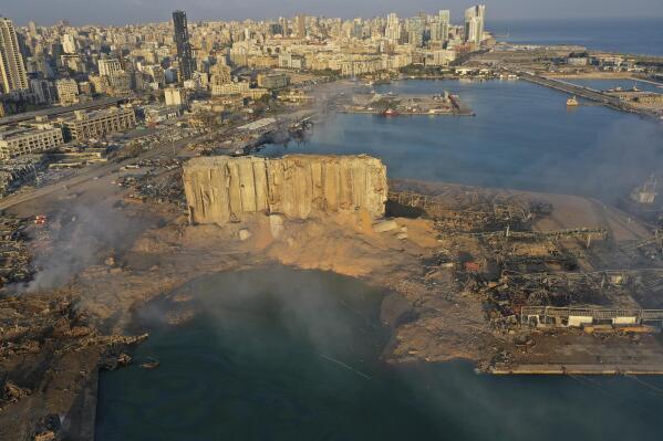 FILE - A drone picture shows the scene of an explosion that hit the seaport of Beirut, on Aug. 5, 2020. Lebanon’s top prosecutor Wednesday Jan. 25, 2023 ordered all suspects detained in the deadly 2020 port blast released, a lawyer for two detainees and judicial officials said. (AP Photo/Hussein Malla, File)