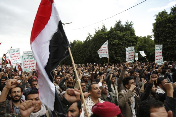 FILE - Houthi supporters chant slogans holding signs reading "Death to America, Death to Israel", as they attend a rally marking eight years for a Saudi-led coalition, Friday, March 26, 2023, in Sanaa, Yemen. For years, the Houthi rebels controlling northern Yemen have chanted slogans at their mass rallies calling for the destruction of Israel. But they never joined any conflict beyond the confines of their own country’s civil war or nearby in the Arabian Peninsula. The Iranian-backed Shiite Muslim force has launched at least six drone and missile attacks toward southern Israel since the Israel-Hamas war began on Oct. 7. (AP Photo/Hani Mohammed, File)