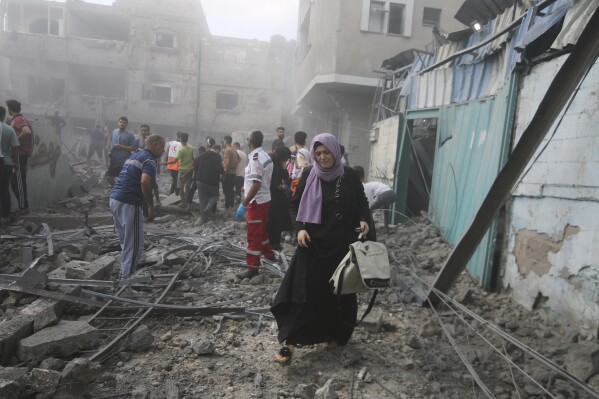 Palestinians look for survivors after an Israeli airstrike in Rafah refugee camp, southern Gaza Strip, Thursday, Oct. 12, 2023. (AP Photo/Hatem Ali)