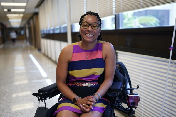 Kimberlyn Barton-Reyes, who is paraplegic and visually impaired, poses for a photo at a rehabilitation center, Wednesday, Aug. 23, 2023, in Austin, Texas. For Barton-Reyes, the Affordable Connectivity Program is a lifeline and its one-time allocation of $14.2 billion is projected to run out by the middle of 2024. That could end access to affordable broadband for her and more than 20 million households. (AP Photo/Eric Gay)