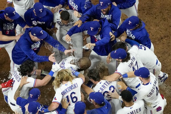 Texas Rangers' Adolis Garcia celebrates after hitting a game-winning home run against the Arizona Diamondbacks during the 11th inning in Game 1 of the baseball World Series Friday, Oct. 27, 2023, in Arlington, Texas. The Rangers won 6-5. (AP Photo/Godofredo A. Vásquez)