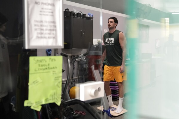 Damon LaSalle does rehab exercises before returning to volleyball following an ankle injury, Friday, Feb. 21, 2025, at New Jersey City University in Jersey City, N.J. (AP Photo/Julia Demaree Nikhinson)