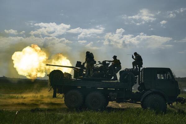 FILE - Ukrainian soldiers fire a cannon near Bakhmut, an eastern city where fierce battles against Russian forces have been taking place, in the Donetsk region, Ukraine, Monday, May 15, 2023. Ukrainian President Volodymyr Zelenskyy said Sunday, May 21, 2023 that Russian forces weren't occupying Bakhmut, casting doubt on Moscow's insistence that the eastern Ukrainian city had fallen. The fog of war made it impossible to confirm the situation on the ground in the invasion’s longest battle, and the comments from Ukrainian and Russian officials added confusion to the matter. (AP Photo/Libkos, File)
