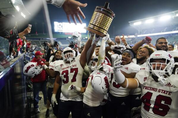 Fresno State players hoist the Old Oil Can trophy while celebrating the team's 30-20 win against San Diego State in an NCAA college football game Saturday, Oct. 30, 2021, in Carson, Calif. (AP Photo/Jae C. Hong)