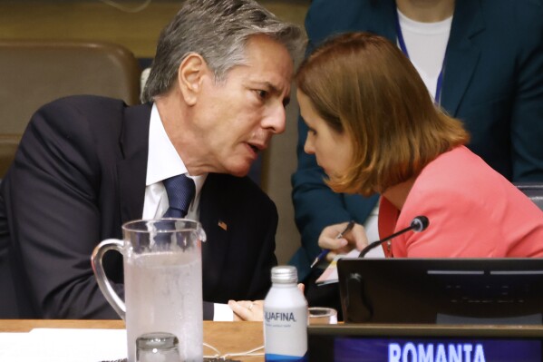 Secretary of State Antony Blinken speaks to Romania's Foreign Minister Luminita Odobescu during the Advancing the Sustainability and Adaptability of the Women, Peace and Security Agenda meeting during the 78th session of the United Nations General Assembly, Thursday, Sept. 21, 2023. (AP Photo/Jason DeCrow, Pool)