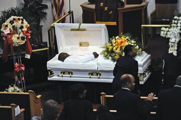 FILE - In this July 23, 2014, file photo, Eric Garner's body lies in a casket during his funeral at Bethel Baptist Church in the Brooklyn borough of New York. New York Attorney General Letitia James' inability to secure charges against Rochester police officers shown on video holding Daniel Prude to the pavement until he stopped breathing shows the difficulty in prosecuting officers who use deadly force. (Julia Xanthos/New York Daily News via AP, Pool, File)