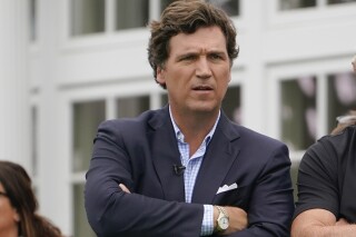 FILE - Tucker Carlson attends the final round of the Bedminster Invitational LIV Golf tournament in Bedminster, N.J., July 31, 2022. Social media users are falsely claiming that an image from a non-governmental organization is proof that Carlson is on a "kill list" in Ukraine. (AP Photo/Seth Wenig, File)