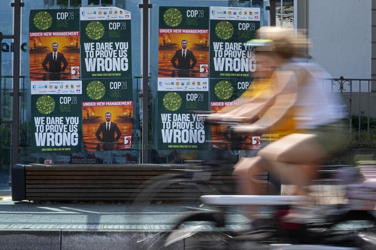 Posters depicting Sultan al-Jaber, the COP28 President, are displayed at a bus stop outside the United Nations Climate Change Conference in Bonn, Germany, June 8, 2023. (AP Photo/Martin Meissner)