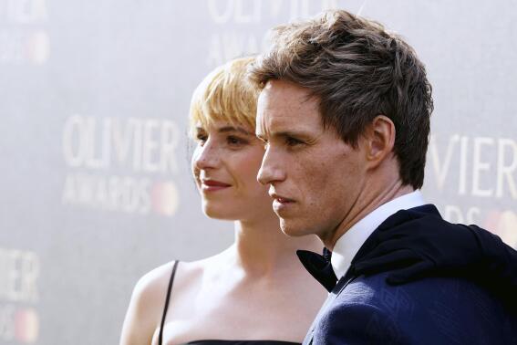 Jessie Buckley, left, and Eddie Redmayne arrive for the Laurence Olivier Awards at the Royal Albert Hall, London, Sunday April 10, 2022. (Ian West/PA via AP)