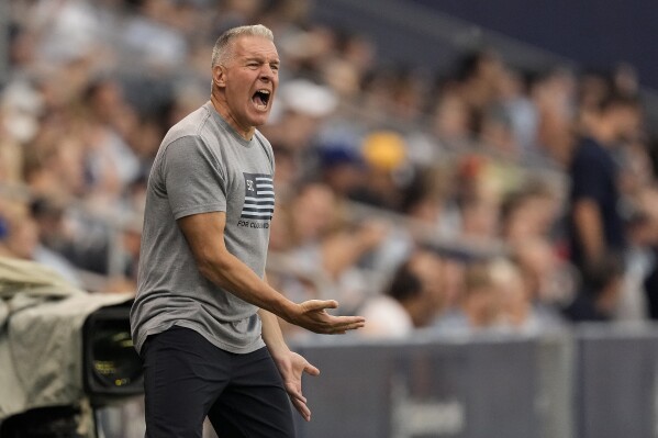Sporting Kansas City manager Peter Vermes talks to his players during the first half of an MLS soccer match against the Vancouver Whitecaps Saturday, July 1, 2023, in Kansas City, Kan. (AP Photo/Charlie Riedel)