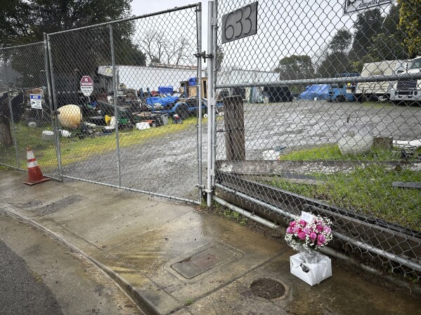 Flowers sit outside the property where San Francisco Bay Area prosecutors say Maximilian Snyder killed landlord Curtis Lind in Vallejo, California, Friday, Jan. 31, 2025. (AP Photo/Janie Har)