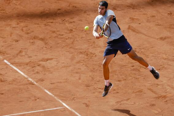Spain's Carlos Alcaraz returns a ball to Germany's Nicola Kuhn , at the Hamburg tennis tournament, Germany, Tuesday, July 19, 2022. (Frank Molter/dpa via AP)